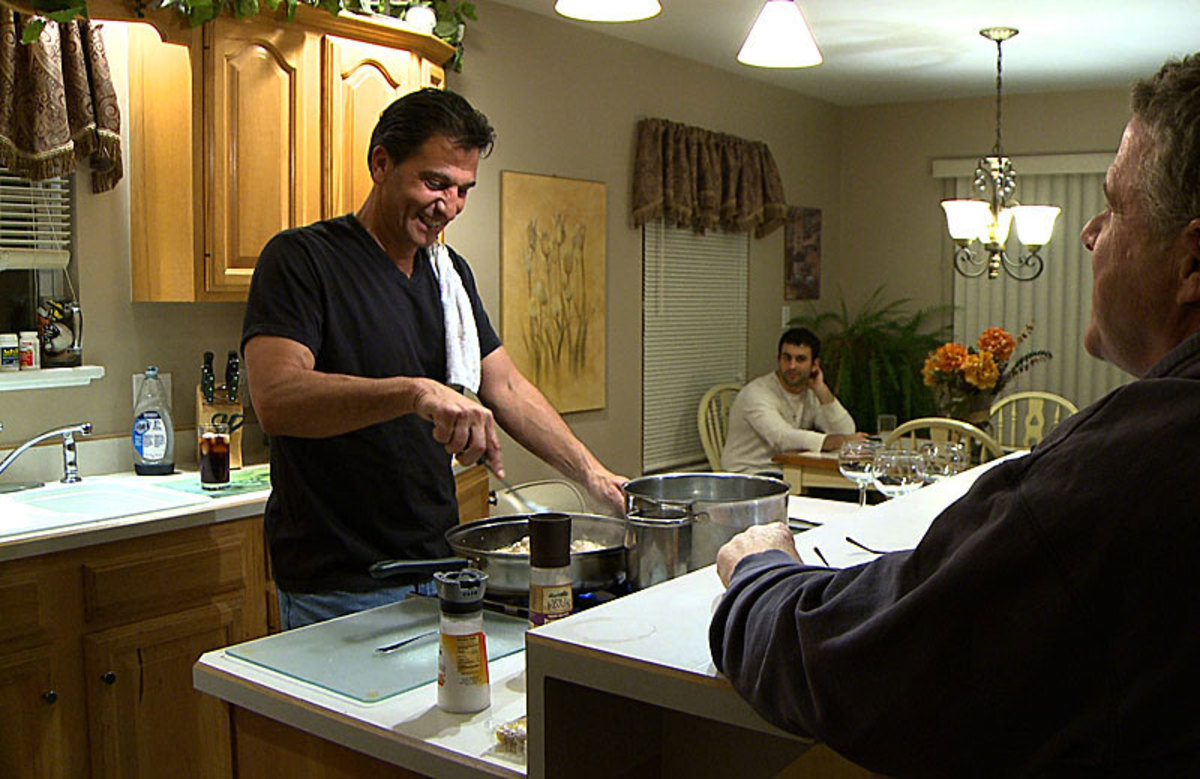 Gene Steratore, with son Geno in the background, in his kitchen a day after the Texans-Cardinals game in Arizona
